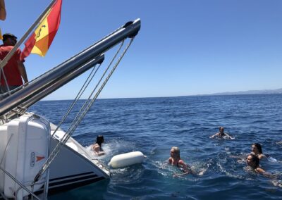 People enjoying a boat tour and a refreshing swim in the open sea in Benalmádena